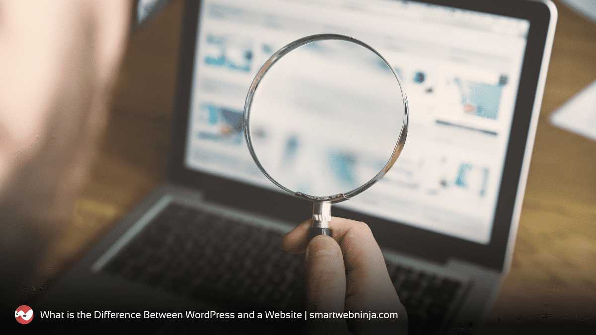 Man holding magnifying glass against a laptop